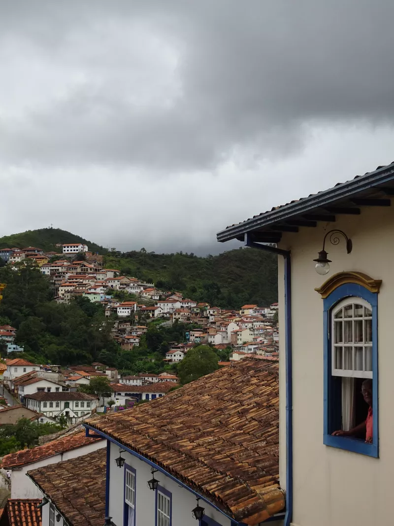 Brasilian man looking out a window
